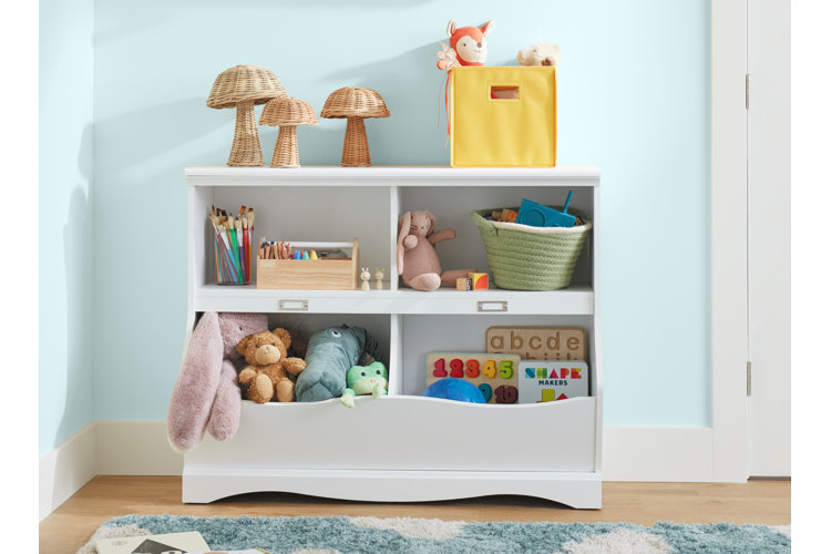 A white toy organizer with four storage compartments to store art supplies, stuffed animals, and educational games.