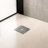 FINE FIXTURES Square Shower Floor Drain, 4 inch Slotted Grate Design, 10-Gauge 304 Stainless Steel, Center Outlet, Fast Drainage, Hair Strainer Included-126703048