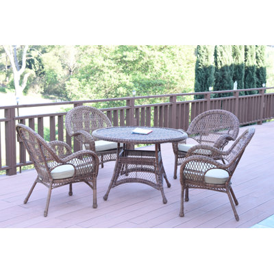 Mangum 4 - Person Wicker Patio Dining Set with Round Table