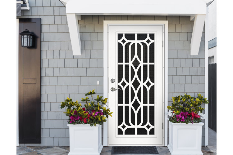 white frame screen door on a gray shingled house