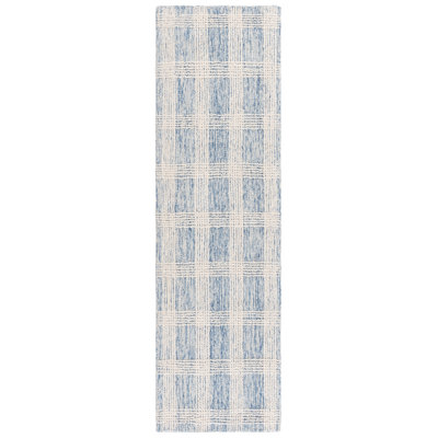 Runner rug in blue and ivory with a geometric plaid pattern