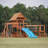 Dolphin Playground Luxury Cedar Playground Set: Double Wave Slide, 2-in-1 Table, Monkey Bars, Balance Beam, 3 Swings, Large Rock Wall, Wood Roof