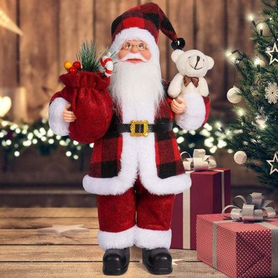 3Pcs 12Inch Christmas Santa Figurines Standing Buffalo Plaid Santa Claus Figure Holding Gifts Bag With Artificial Green Spruce & Red Berry For Holdiday Winter Home Table Xmas Party