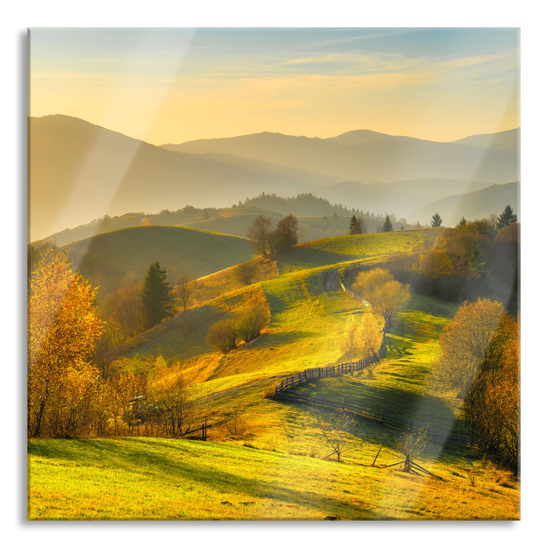 Glasbild Hügelige Herbstlandschaft bei Sonnenuntergang