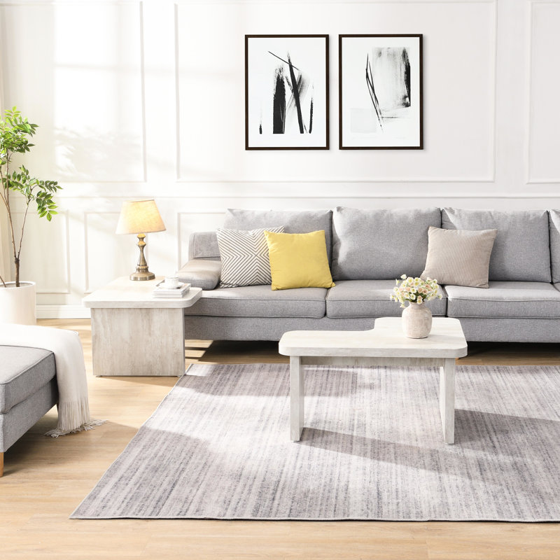 Table basse blanche en forme de L, 123 x 61 cm et 90 x 80 cm détachables, idéale pour un hall d'entrée, un jardin ou une salle à manger conviviale. Structure facile d'entretien.
