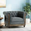 Élégant fauteuil club avec tissu gris anthracite, capitonnage à boutons profonds profonds, accoudoirs courbés, garniture cloutée, structure de pieds en bois de bouleau rafraîchissant, base intense