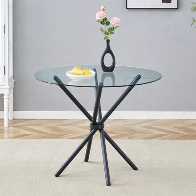Une table ronde circulaire en verre trempé transparent d'un diamètre de 36,6 pouces, avec des pieds en métal noir rassemblés en forme d'anneau. Le verre du bureau mesure 0,3 pouce d'épaisseur.