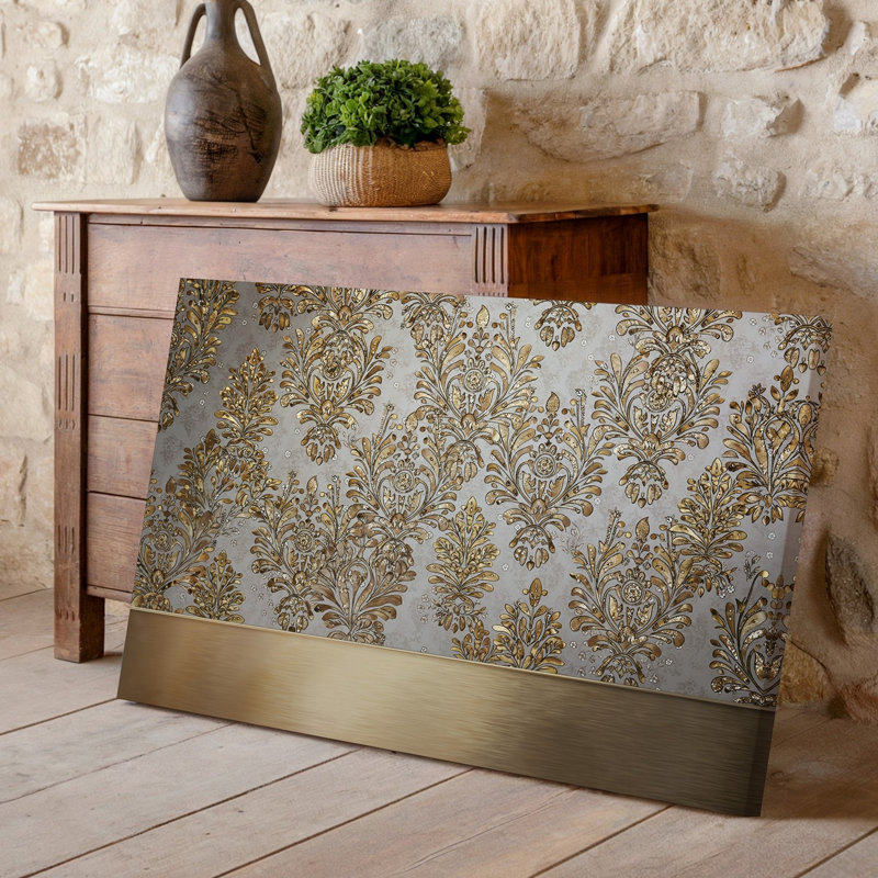La toile crée un design de papier peint élégant avec un motif damassé complexe en or chatoyant contre un taupe doux
