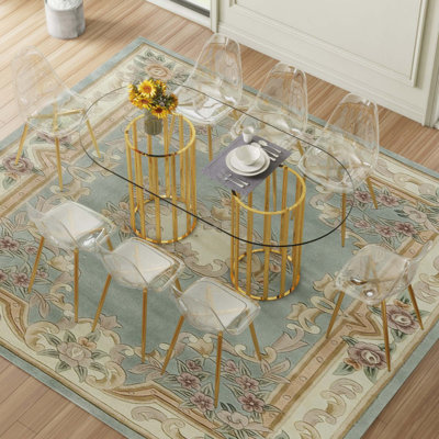 Ensemble de table et de chaises Table de salle à manger ovale en verre trempé de 71 pouces de style luxueux à double colonne. Jumelé avec 6 chaises en plastique transparent avec pieds en métal.