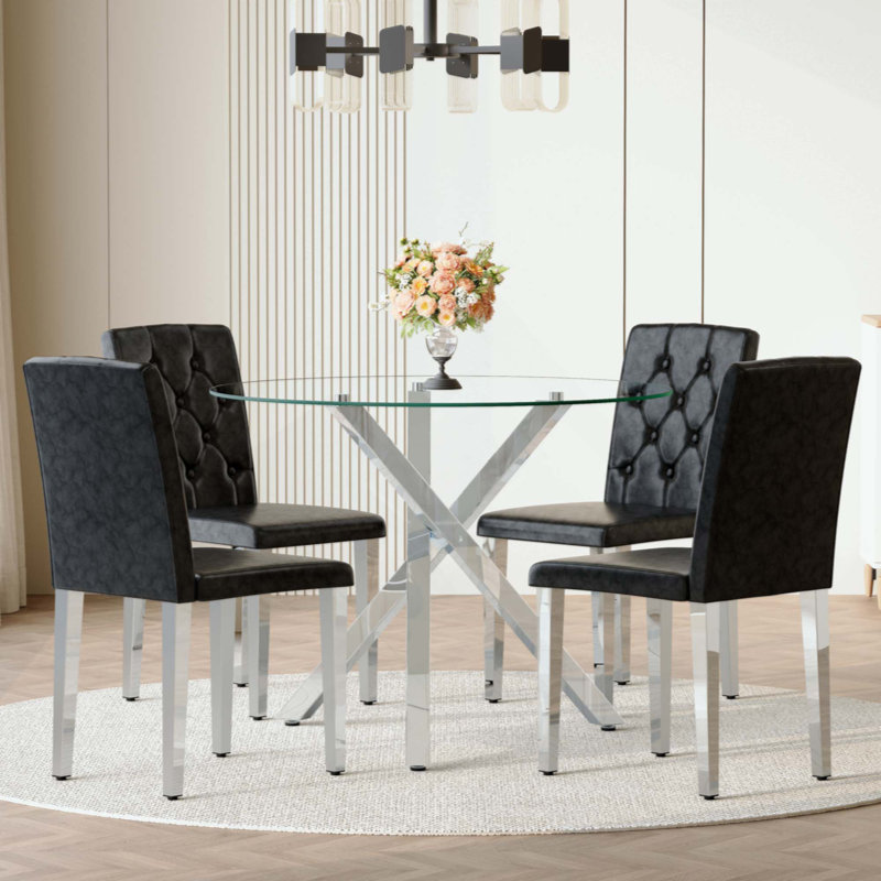Ensemble de table et de chaises. Table ronde en verre moderne: 39 po de diamètre, support en métal argenté en forme de X. Jumelé avec 4 chaises de salle à manger en polyuréthane noir avec dossier ergonomique à boucle. Convient aux restaurants et aux cuisines.