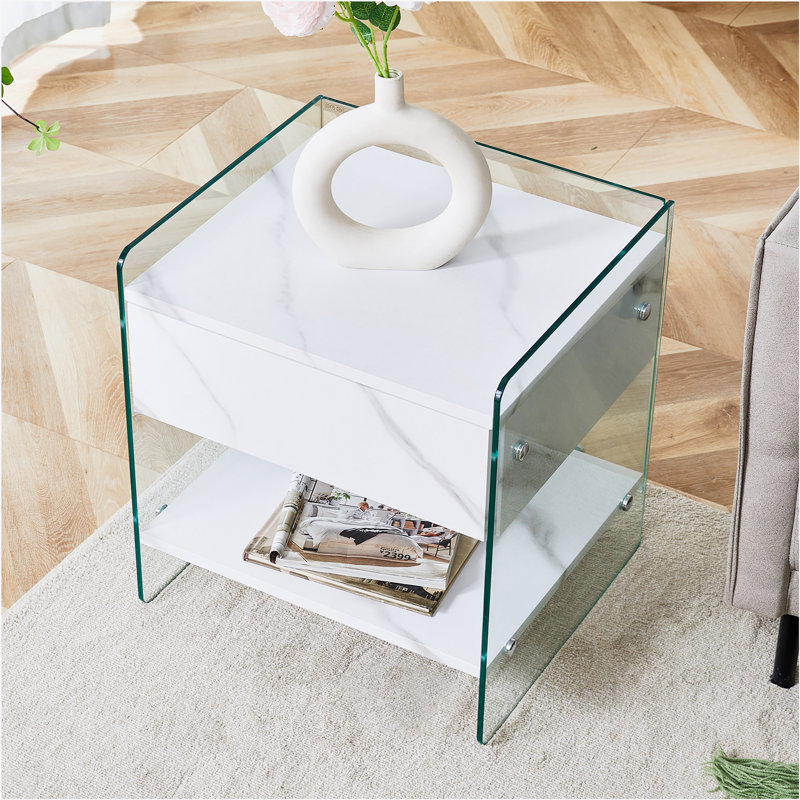 Bedside table with drawers. The board surface is MDF with white grain sticker, and both sides are transparent tempered glass. The design is simple and elegant, with excellent storage functions.