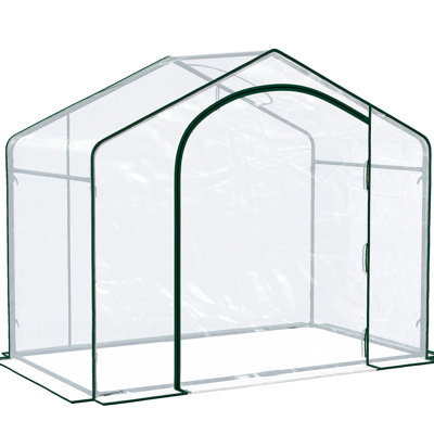 Serre accessible à pied avec parois transparentes et ventilation pour prolonger la saison de croissance des plantes