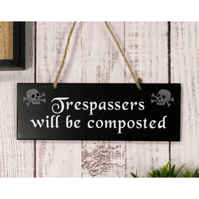 The Holiday Aisle® Pack Of 2 Halloween Witchraft Wicca Occult 'Trespassers Will Be Composted' Crossed Bones Skull Gardening Theme MDF Wood Wall Hanging Sign Plaque Decor Hocus Pocus Alchemy Magic Accent