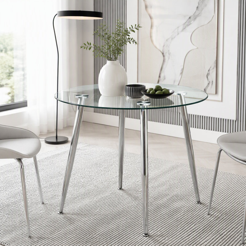 Table de salle à manger ronde avec dessus en verre et pieds argentés