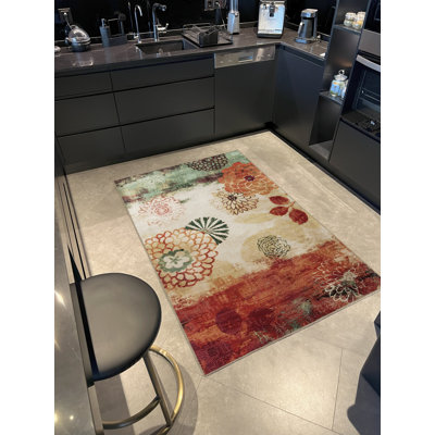 Tapis décoratif vert et rouge à motif floral multicolore