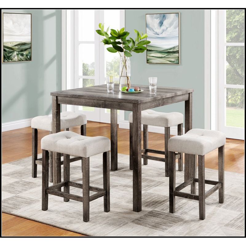Ensemble table haute de bar cinq pièces avec tabourets capitonnés pour des repas élégants et des réceptions conviviales à la maison