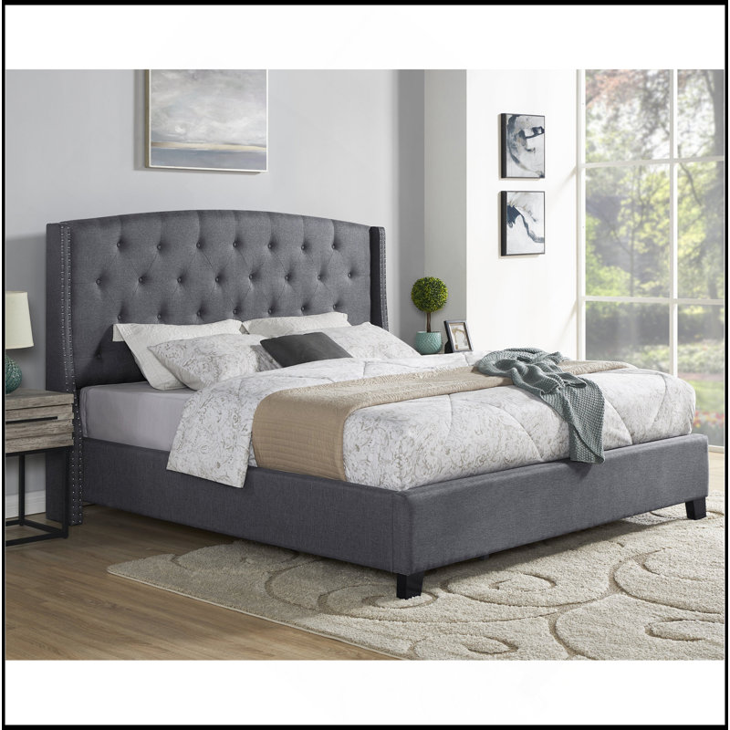 Élégant lit capitonné à oreilles capitonné en tissu pour une expérience de sommeil luxueuse et confortable.