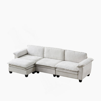 Canapé rembourré de luxe en L en chenille avec repose-pieds pour un confort spacieux et une élégance de salon moderne.