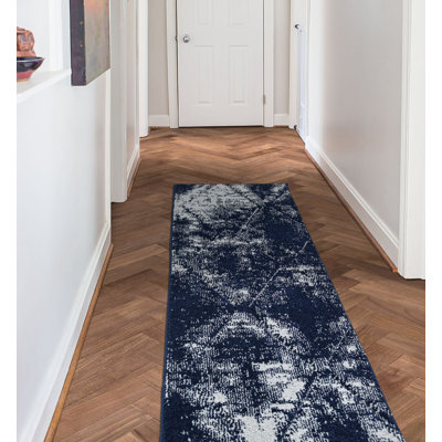 Tapis bleu marine / blanc abstrait touffeté