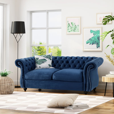 Style classique en velours bleu marine avec des pieds élégants et capitonnés