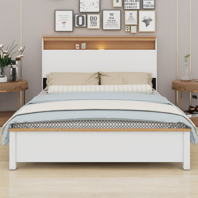 The Rustic Farmhouse Bed Frame With Storage Headboard Comes With A Built-In Charging Station by Ebern Designs