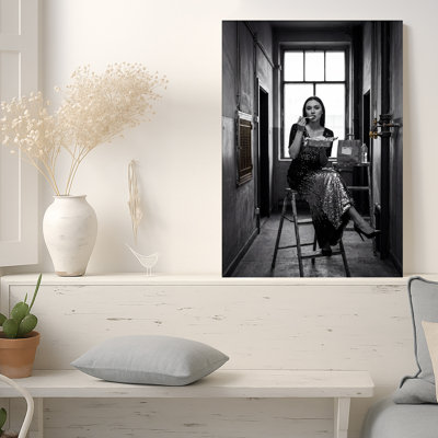 «Woman in Sequin Dress Eating on Ladder in Industrial Hallway», art mural sur toile noir et blanc