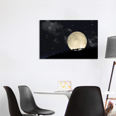 A Full Moon Rising Behind A Row Of Hilltop Trees by Marc Ward - Wrapped Canvas Print
