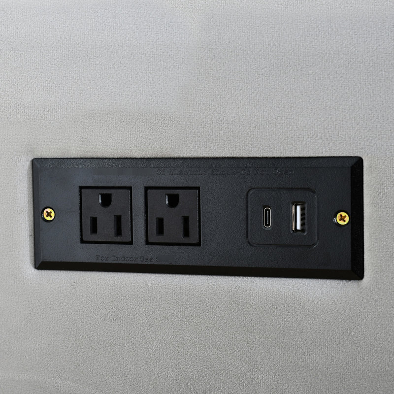 Grand lit tapissier en velours gris avec prises électriques et plateforme de rangement latérale pour deux personnes