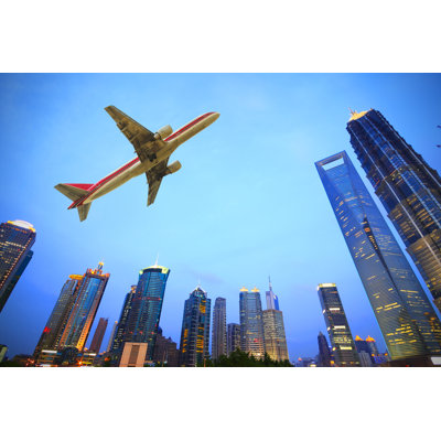 Zubley Aircraft Flying Over City - Wrapped Canvas Print