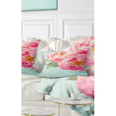 Coussin lombaire floral sur fond pivoine