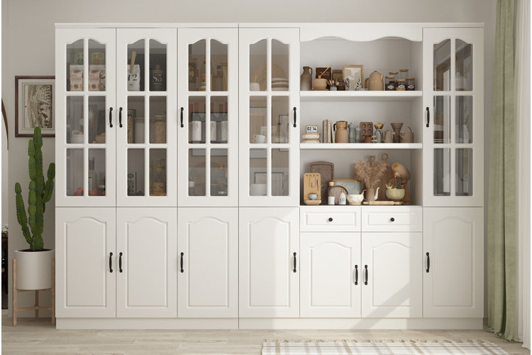 white dining room hutch with glass cabinet doors and open shelves displaying dishes, jars, and decorative accents