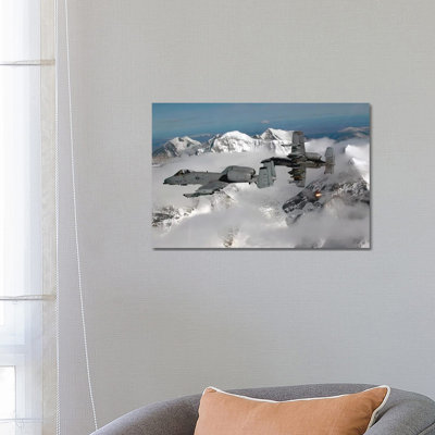 A-10 Thunderbolt IIs Fly Over Mountainous Landscape by Stocktrek Images - Wrapped Canvas Print