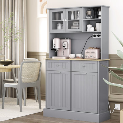 68" Gray Kitchen Pantry Storage Cabinet With Charging Feature. Freestanding Glass Doors & Adjustable Shelf. For Various Uses. 2 Tilt Out Trash Cabinets. Built-In Ac Outlets And Ports. Spacious
