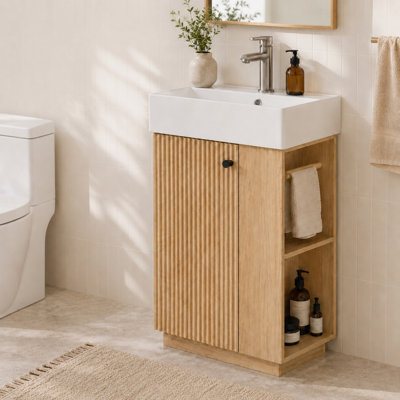 Meuble-lavabo autoportant de 55 cm de largeur, avec rangement latéral ouvert et dessus en céramique.