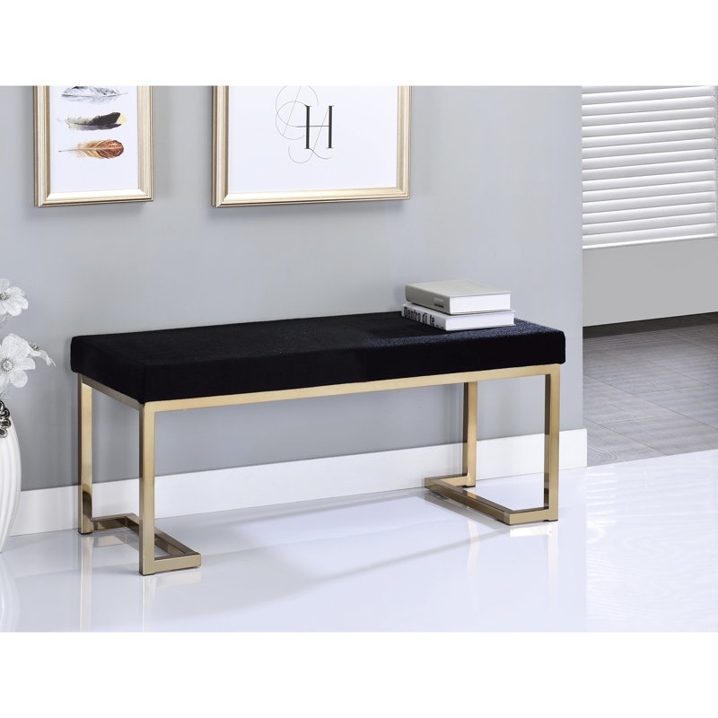 Banc noir en fausse fourrure avec assise moelleuse et base champagne élégante