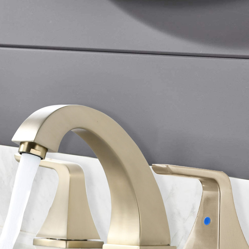 Robinet de salle de bain à entraxe de 61 mm (2 8 po), fini doré brossé, avec bonde escamotable et résistant à l'usure. Deux poignées, bonde, finition sur le plan de travail.