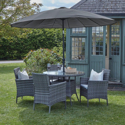 Dubose 4 - Person Wicker Patio Dining Set with Round Table , Cushions Included