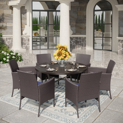 Sutiya 6 - Person Stainless Steel Patio Dining Set Umbrella Hole Included Round Table with Cushions Included