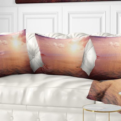 Coussin lombaire bleu ciel au-dessus d’une plage de couleur coucher de mer rose