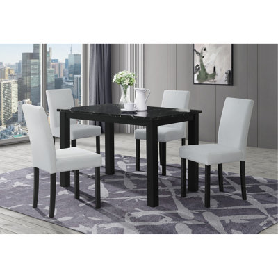 Table de salle à manger noire et (4) chaises de salle à manger argentées