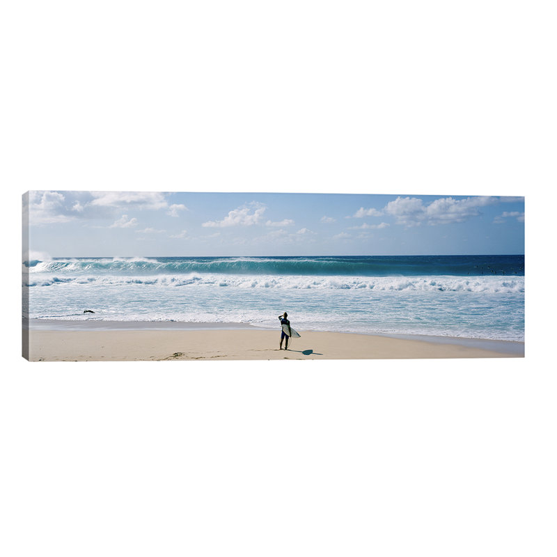 Surfer Standing On The Beach North Shore, Oahu, Hawaii, Usa by Panoramic Images - Wrapped Canvas Panoramic Print