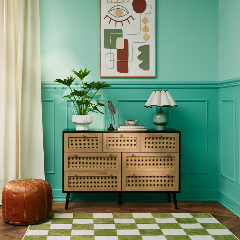 Two-drawer oak nightstand with bronze handles and base.