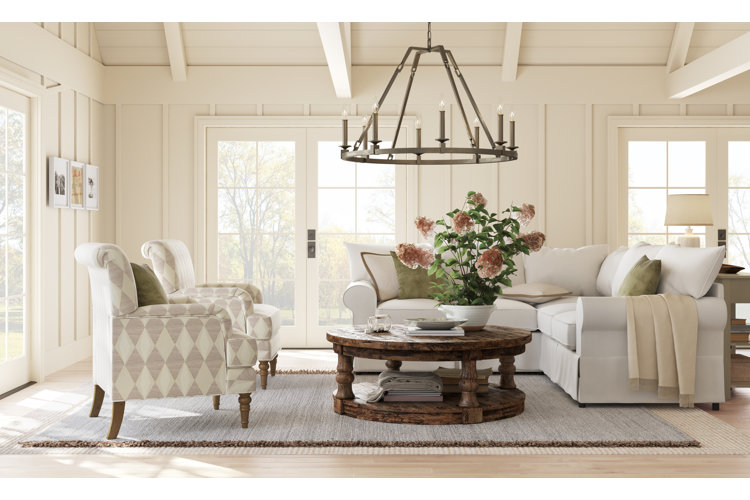 neutral-toned living room with a rustic wagon wheel chandelier