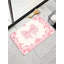 Tapis de bain rose à motif de nœuds papillon 36 x 24