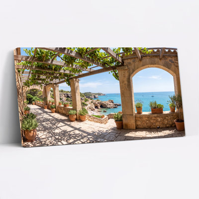 Art mural sur toile en pierre avec vignes et mer turquoise