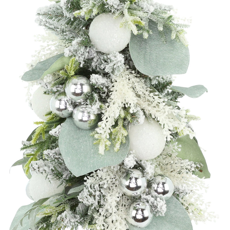 Arbre de Noël floqué avec feuilles et ornements magnolia