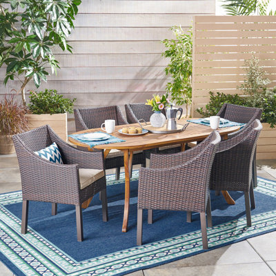 Morra 6 - Person Acacia Wicker Patio Dining Set with Oval Table , Cushions Included