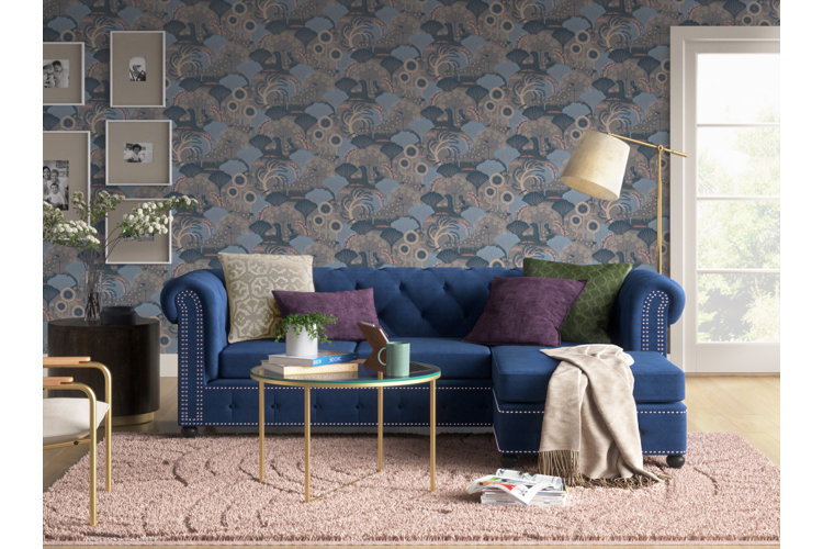 Blue and purple living room colors with a blue sofa and blue-purple wallpaper.