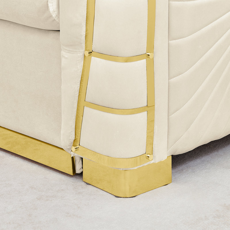 Sofa une place en velours avec des détails métalliques dorés et un coussin décoratif
