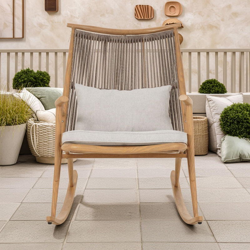 Fauteuil à bascule rustique d'extérieur avec structure en fer résistant aux intempéries, dossier et coussins en rotin en PE